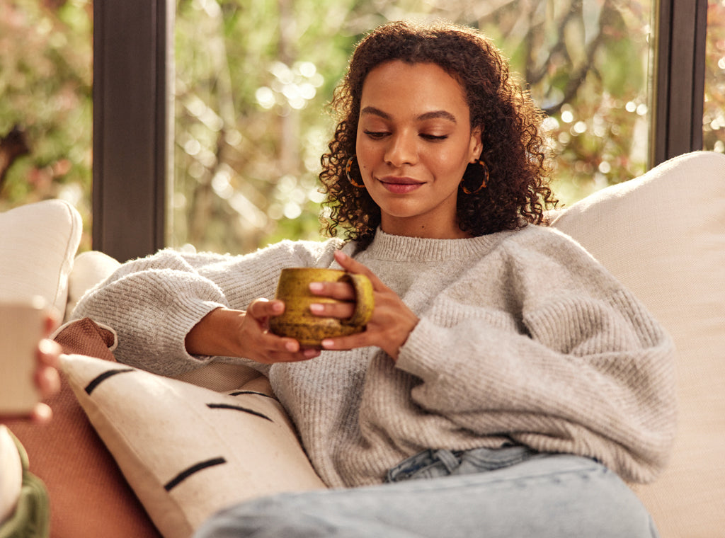 A woman and a coffee mug, finding calm in coffee