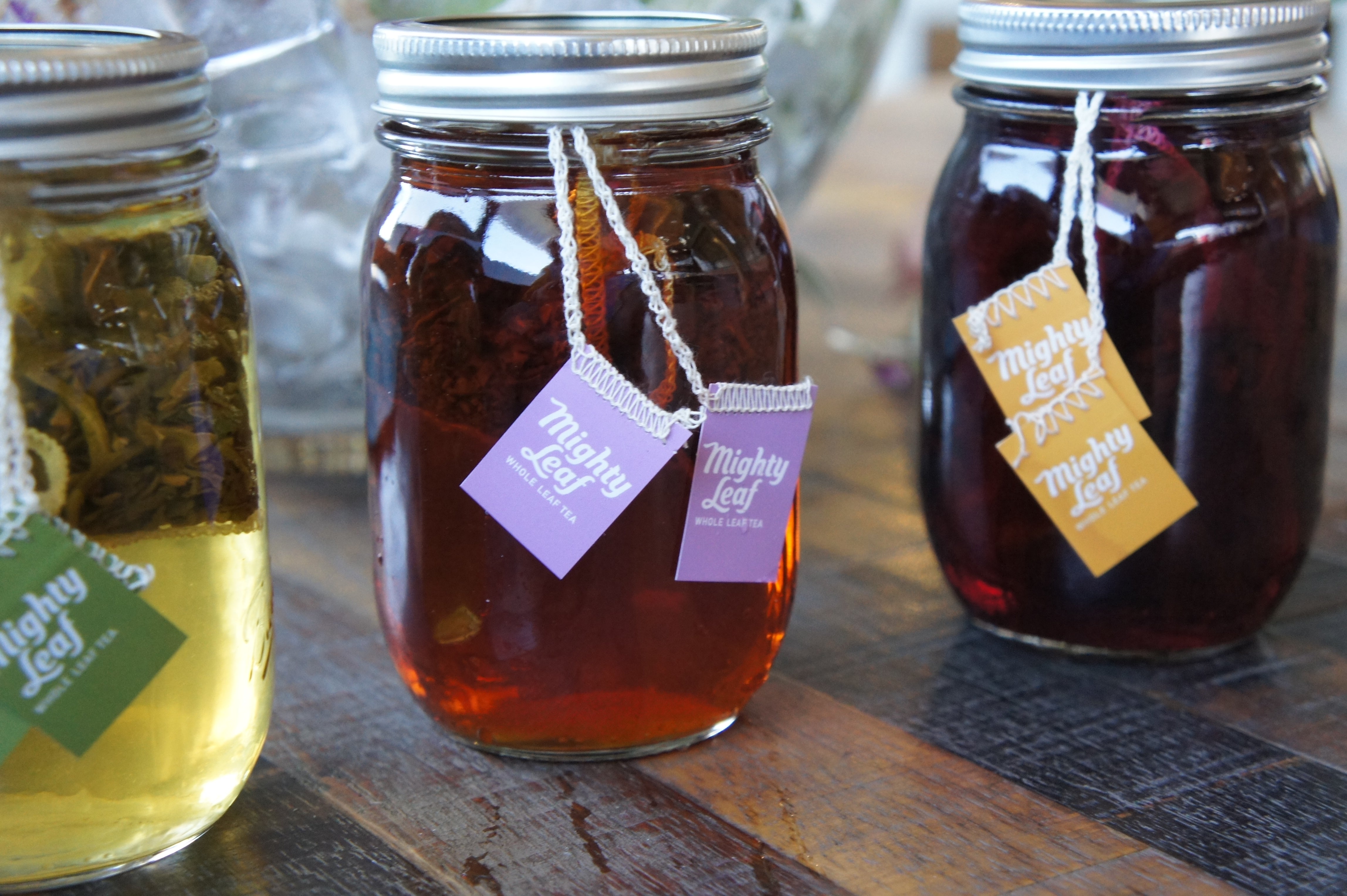 Three mason jars containing flash brewed Mighty Leaf green tea, black tea, and herbal tea.