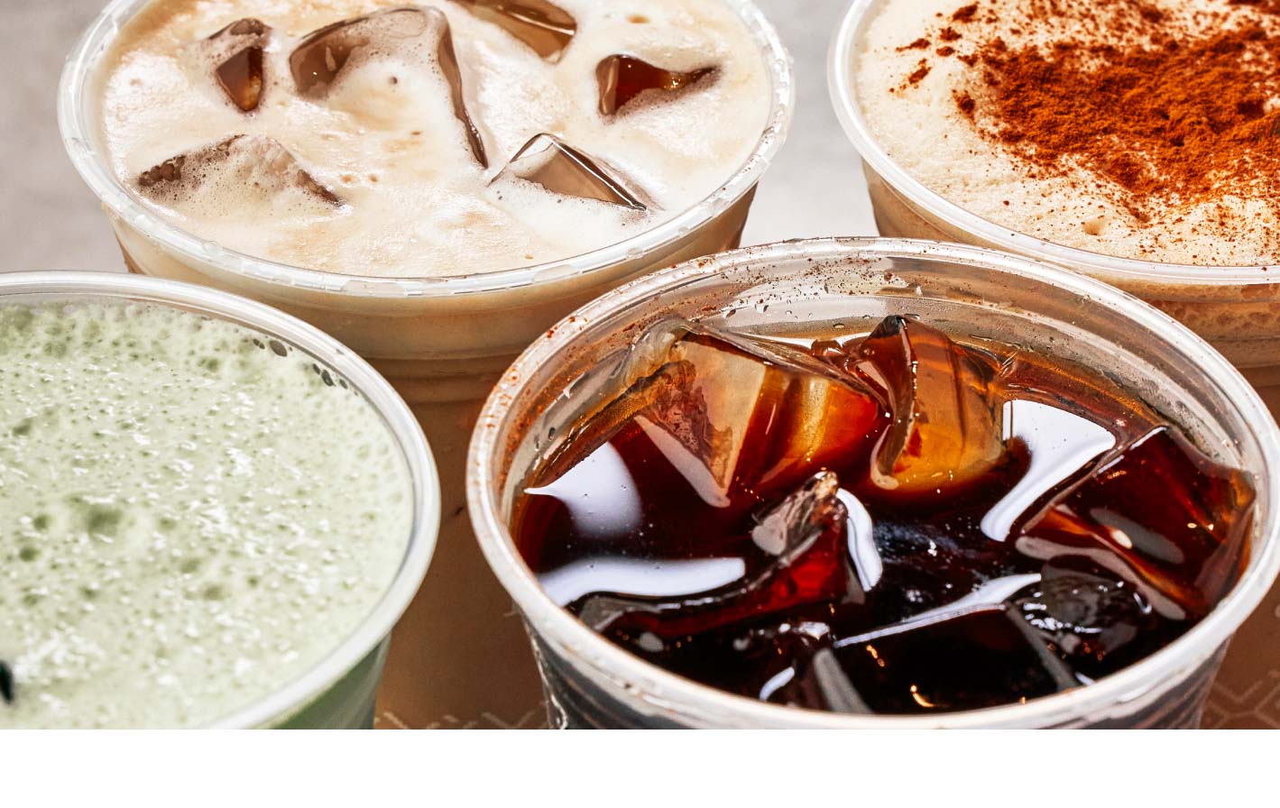 Close up of four iced beverages next to each other on a table