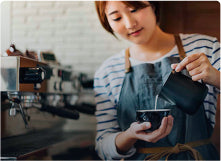 Barista making a latte in coffeebar