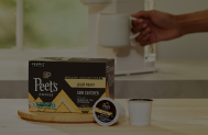 Box of k-cups on a counter in front of a coffee machine